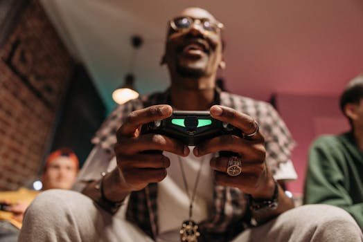 Excited man holding a controller while immersed in a video game, enjoying leisure time indoors.