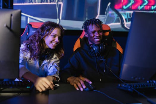 Multiracial friends gaming with computers and headphones, enjoying esports indoors.