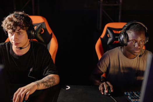 Two focused gamers wearing headsets in a cyber cafe, engaged in a competitive online match.