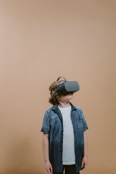 Young boy wearing VR headset, immersed in virtual reality experience indoors.